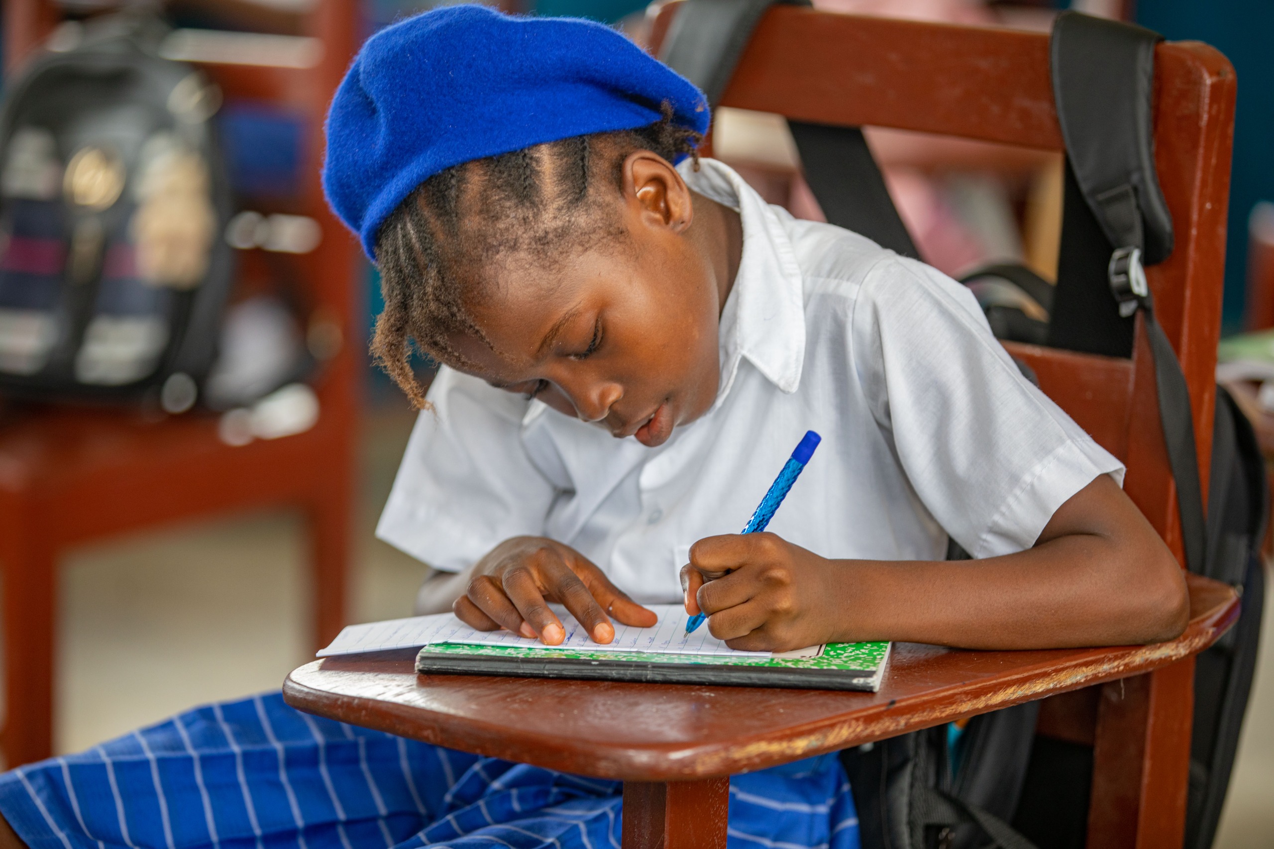 Student writing in classroom